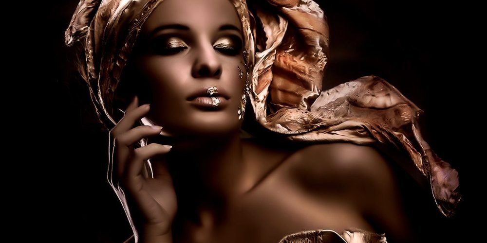 Feminine ways to manifest money with grace and magnetism — a woman surrounded by golden light, symbolizing abundance and soft power | The Sublime Woman