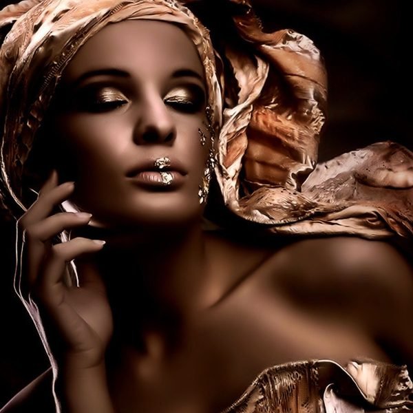 Feminine ways to manifest money with grace and magnetism — a woman surrounded by golden light, symbolizing abundance and soft power | The Sublime Woman