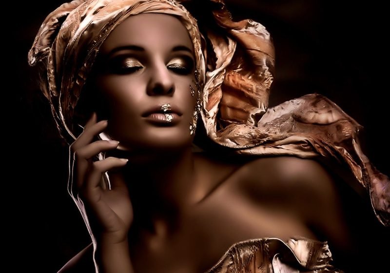 Feminine ways to manifest money with grace and magnetism — a woman surrounded by golden light, symbolizing abundance and soft power | The Sublime Woman