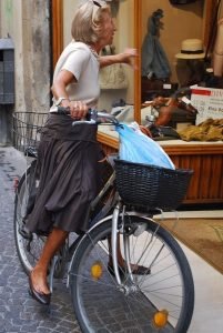 Old lady sitting on the bicycle