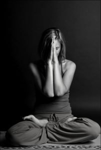 Woman sitting in lotus yoga pose