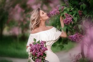 Beautiful blonde woman with lilac flower, Feminine Exercise | The Sublime Woman