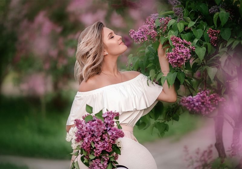 Beautiful blonde woman with lilac flower, Feminine Exercise | The Sublime Woman
