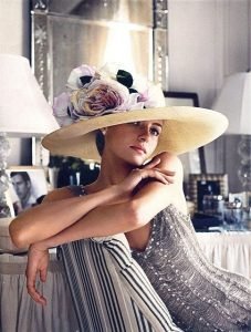 Elegant young woman in a dress with hat
