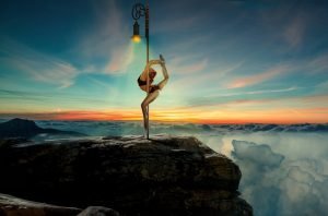 Beautiful sexy woman back-bending on the pole feminine exercise | The Sublime Woman