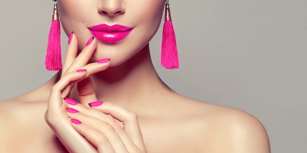 15 Ways To Replenish Your Feminine Energy woman with pink nails and lips pink earrings | The Sublime Woman