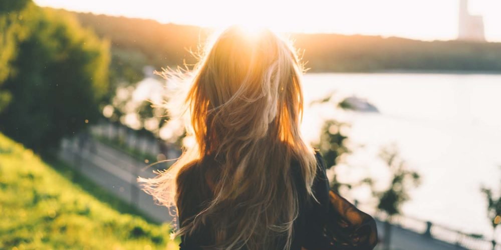 How to Stop Losing Energy, Woman with long hair by the water, feminine energy | The Sublime Woman