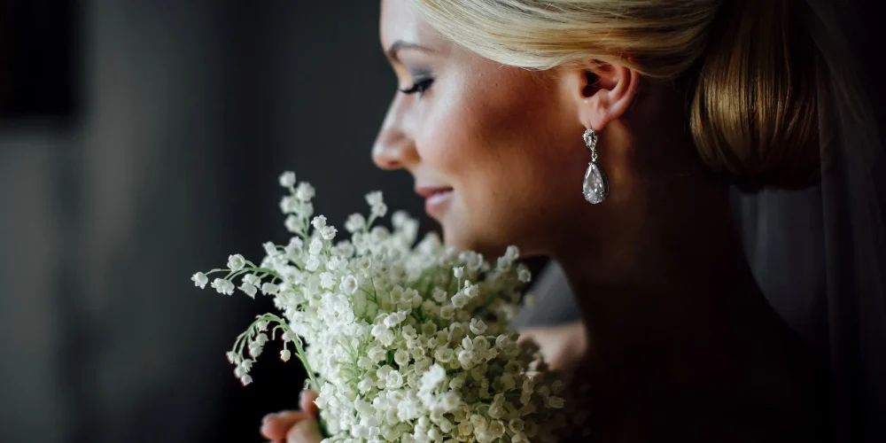 Blonde woman holding flowers energetic hygiene for women | The Sublime Woman
