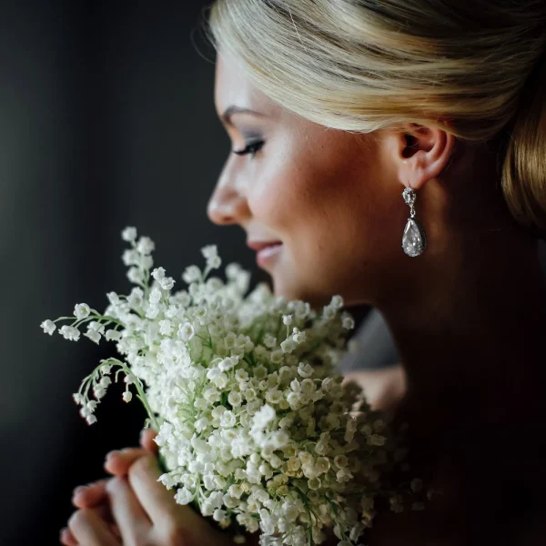Blonde woman holding flowers energetic hygiene for women | The Sublime Woman