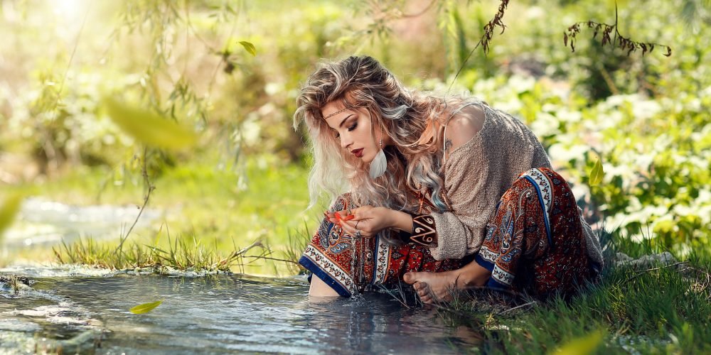 Woman watching the water slavic blond beauty flowers in hair wise woman's energy secrets | The Sublime Woman