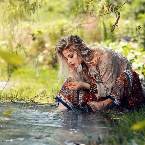 Woman watching the water slavic blond beauty flowers in hair wise woman's energy secrets | The Sublime Woman