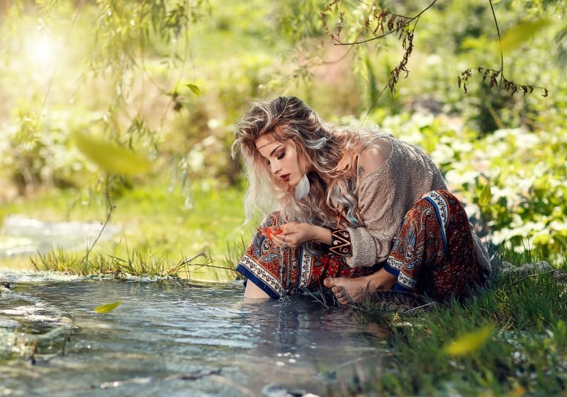 Woman watching the water slavic blond beauty flowers in hair wise woman's energy secrets | The Sublime Woman