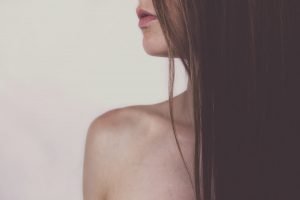 Young woman with long hair brushing with essential oils | The Sublime Woman