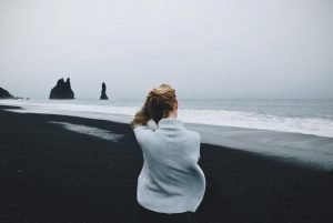 Strengthening energy protection aura exercise woman sitting on the beach | The Sublime Woman