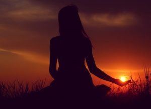 Energy Sources For Woman woman sitting looking at sunset | The Sublime Woman