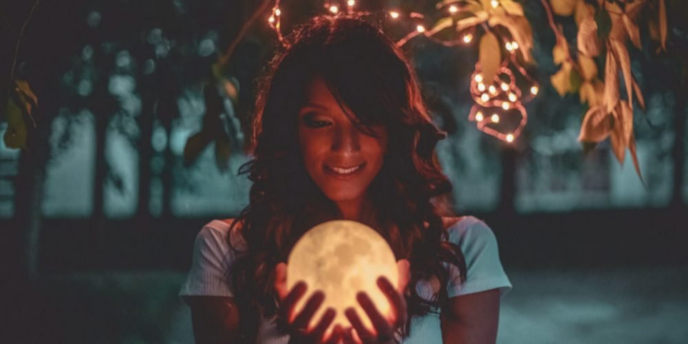 Vedic Astrology for Wise Women woman holding a moon | The Sublime Woman