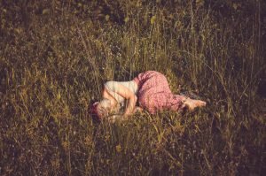 Feminine Rest Relaxing like a Woman beauiful woman laying in the field of flowers | The Sublime Woman