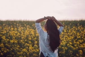 Woman's Dignity beautiful woman with long hair in the field of wild flowers | The Sublime Woman