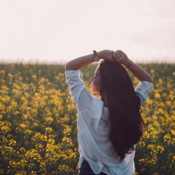 Woman's Dignity beautiful woman with long hair in the field of wild flowers | The Sublime Woman