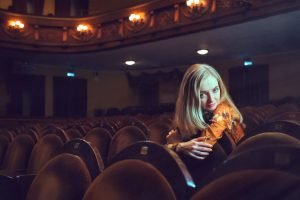 Movie and Chakras Beautiful blonde woman in a theater | The Sublime Woman