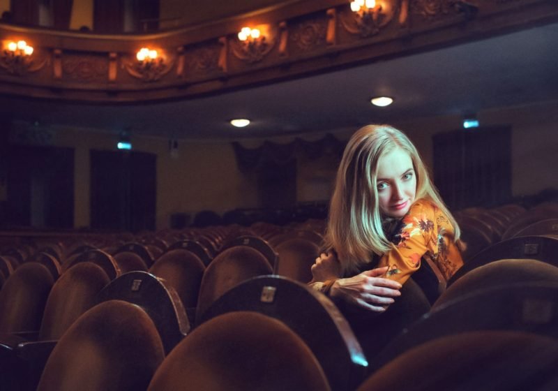 Movie and Chakras Beautiful blonde woman in a theater | The Sublime Woman