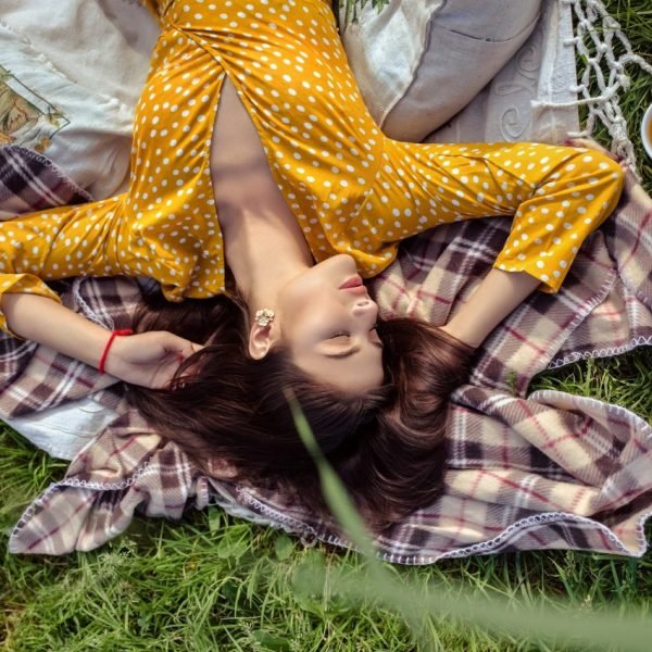 Dangers Of Woman's Desire To Help, Depletion From Too Much Helping, Beatiful Woman laying relaxing on Eart Green garss yellow dress, The Sublime Woman